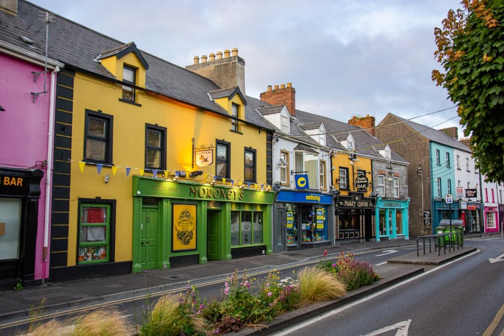 Colorful buildings line a street under a cloudy sky