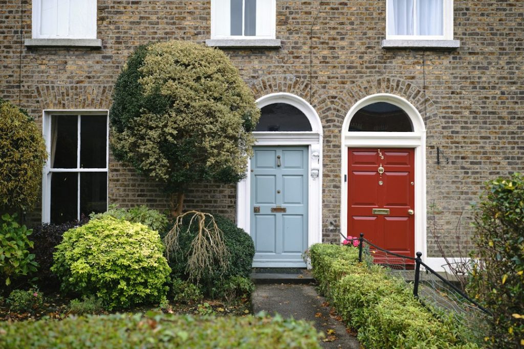 a house with a red door and a blue front door